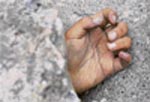 The hand of a dead student is buried among the ruins of a destroyed primary school in the old city district
