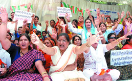 Activists of the Delhi Pradesh Mahila Congress protest against the BJP for not fulfilling its promises of stopping sealing and demolition at the Town Hall in Delhi on Friday. 