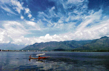 A Kashmiri rides a shikara on the Dal Lake in Srinagar on Friday. Thousands of holiday goers have arrived over the week in the Kashmir valley to enjoy the beauty of its landscape. 