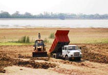 Silt removal operations under way at Sukhna Lake in Chandigarh on Saturday.