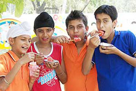Youngsters beat the heat with ice candy in Ambala on Saturday.
