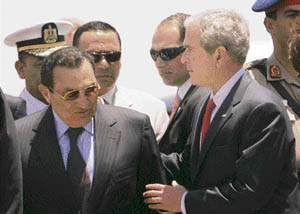 US President George W. Bush (right) walks with Egyptian President Hosni Mubarak at Sharm El-Sheik International Airport in Egypt on Saturday. Bush is pivoting to the Arab side of the Middle East peace dispute, and he may well get a less glowing reception than he did over two days in Israel earlier this week. 