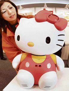 In this file photo, a woman displays a Hello Kitty-shaped communication robot named the "Hello Kitty Robo", manufactured by Japan's robotic venture Business Design Laboratory, at the venture expo in Osaka, western Japan