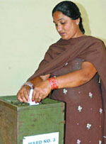 A woman casts her vote at the Delhi Cantt Board elections in New Delhi on Sunday. 