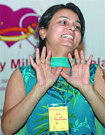 A hearing impaired girl introduces herself for a suitable match at a function in New Delhi on Sunday.