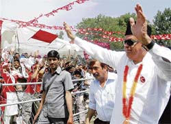 Farooq Abdullah waves to the supporters during a rally at Rafiabad in Baramulla on Sunday.