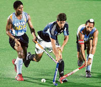 Indias Diwakar Ram (left) and Sardar Singh (right) challenge Argentinas Rodrigo Luis Saliva during the final of the 17th Sultan Azlan Shah Cup in Ipoh, on Sunday. India went down fighting 1-2.