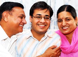 Nitin flanked by his parents