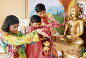 Devotees offer flowers at an idol of Lord Buddha on the occasion of Budh jayanti in Sonepat on Monday. 