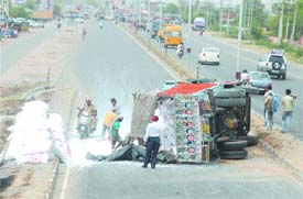 A truck carrying sacks full of limestone overturned near Chugitti, hitting the smooth flow of traffic on the Amritsar-Jalandhar national highway, on Monday.