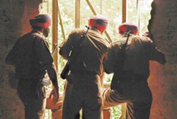 Police personnel inspect a broken wall adjoining the door of Muthoot Finance