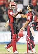 Delhi Daredevils Shikhar Dhawan and Farveez Maharoof after their teams win in the IPL T20 match against Bangalore Royal Challengers at the Chinnaswamy stadium in Bangalore