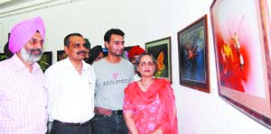 SSP Kunwar Vijay Pratap Singh takes a look at photographs by artist Arsh Rup Singh during an exhibition in Amritsar. 