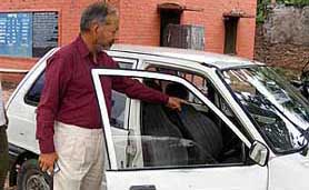 A man shows the car from which Rs 3.9 lakh were stolen in Ambala on Tuesday.