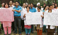 Doctors protesting in support of their demands at Gandhi Nagar Hospital in Jammu on Tuesday.