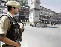 A CRPF jawan keeps a watch in a closed market during a strike call given by the All-Party Hurriyat Conference on the 18th death anniversary of Mirwaiz Maulana Farooq, father of Hurriyat chairman Mirwaiz Umar Farooq, in Srinagar on Wednesday.