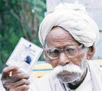 Raghbir, a 75-year-old man, comes out of a polling booth after casting his vote in Kheri Mansingh village in the Indri constituency