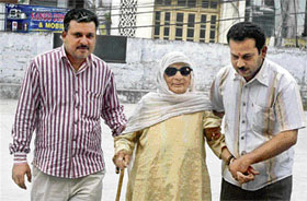 Relatives take 100-year-old Mansa Devi to a polling booth at the Government Senior Secondary School for Girls, Hamirpur, on Thursday. 