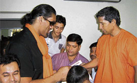 The Great Khali take yoga tips from chief of the Maharishi Patanjali Yoga Foundation, Lonawala, Mumbai, Swami Karamvir.