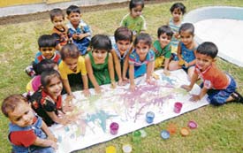 Students of Lovely Lotus School play with colours during a summer camp in Ludhiana on Thursday.
