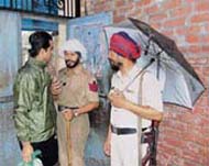 Policemen ask a voter for an Identity card in Amritsar (South) on Thursday.