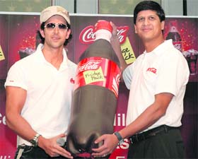 Bollywood actor and Coca-Cola brand ambassador, Hrithik Roshan, and Venkatesh Kini, vice-president, marketing, Coca-Cola India, poses with Coca-Cola fridge pack bottle in New Delhi