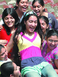 Class XII students celebrate after the results in New Delhi on Friday.