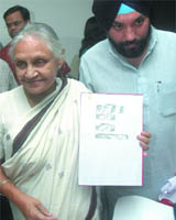 Chief Minister Sheila Dikshit with Delhi education minister Arvinder Singh Lovely shows the list of marks scored by government schools in CBSE at Delhi Secretariat on Friday.