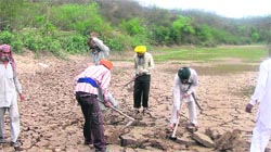 The desilting work gets underway at the Majri dam.