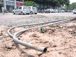 Uprooted electricity poles lie unattended in the parking lot of Sector 47-C market in Chandigarh on Saturday.