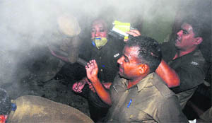 Firemen try to control the fire at Sector-9 in Chandigarh on Saturday.