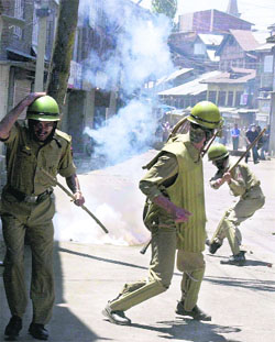 Kashmiri Muslim protesters throw stones at policemen during a strike called by the Hurriyat Conference in Srinagar on Saturday. 