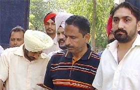 The accused (extreme left) in vigilance custody in Ludhiana