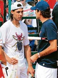 Rafael Nadal (L) of Spain speaks with Roger Federer of Switzerland at training session
