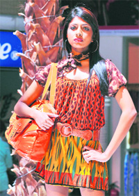 A Sri Lankan model displays locally designed clothes at a fashion show in Colombo on Sunday. Garments account for over 50 per cent of the nations $7.7 billion export earnings, with high quality clothes being shipped to top international labels.