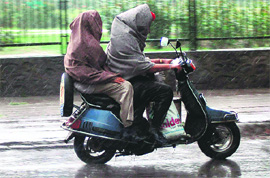 Scooterists caught in rain that lashed Chandigarh on Sunday afternoon.