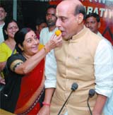 SWEET VICTORY: BJP leader Sushma Swaraj offers a sweet to party president Rajnath Singh after the victory in Karnataka assembly elections in New Delhi on Sunday