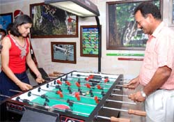 Former Indian cricketer Madan Lal plays symbolic football with the former captain of the Indian women cricket team Anjum Chopra at the launch of the All Sports Bar in New Delhi on Sunday.
