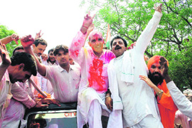 Congress candidate Jagbir Singh Malik and his supporters take out a victory procession in Gohana on Sunday.