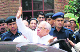 Former Chief Minister Bhajan Lal greets his supporters outside the counting hall in Hisar on Sunday after winning the byelection from the Adampur assembly constituency. 