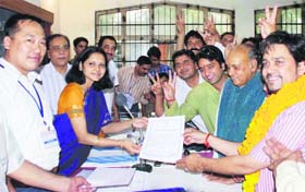 Anurag Thakur, accompanied by his father P.K. Dhumal, receives certificate from the returning officer