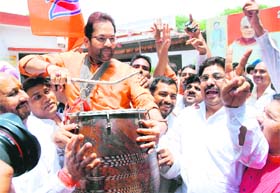 BJP leader Mukhtar Abbas Naqvi celebrates with party workers after securing a win in the Karnataka assembly elections at the party headquarters in New Delhi