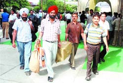 Poll staff carry election material to their respective stations in Jalandhar on Sunday.