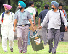 Officials carry election material on the eve of Panchayat Samities polls slated for Monday.
