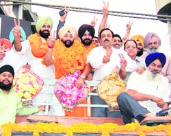 Inderbir Singh Bularia with Bikram Singh Majithia, BJP MP Navjot Singh Sidhu during a victory rally in Amrtisar on Sunday. 