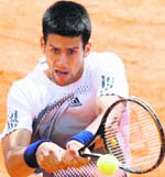 Novak Djokovic of Serbia returns the ball to Denis Gremelmayr of Germany at the French Open at Roland Garros stadium in Paris on Sunday. Djokovic won 4-6 6-3 7-5 6-2. 