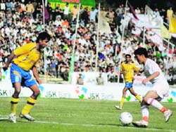 Jammu and Kashmir and Pudducherry players in action during the first match of the 62th National Santosh Trophy at Bakshi Stadium in Srinagar on Sunday. 