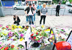 Friends of 18-year-old actor Rob Knox pay their respects at the scene where he was stabbed and killed in the early hours of Sunday, in Sidcup, Kent. Knox, an actor in the forthcoming Harry Potter film, was stabbed to death during a fight outside a London bar.