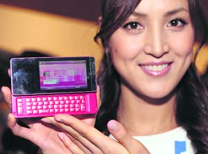 A model shows off Willcom's new smartphone, "Willcom 03", a Japanese Personal Handyphone System (PHS), in Tokyo on Monday. Equipped with a Marvell PXA270-520MHz processer and Microsoft Windows Mobile 6.1 Classic Japanese version, the Willcom 03 smartphone will be introduced onto the Japanese market from late June this year. 