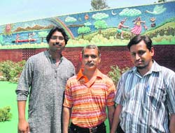 Vishal Bhatnagar, Subhash Shorey and Rajender Kumar pose with the mural work in Chandigarh. 